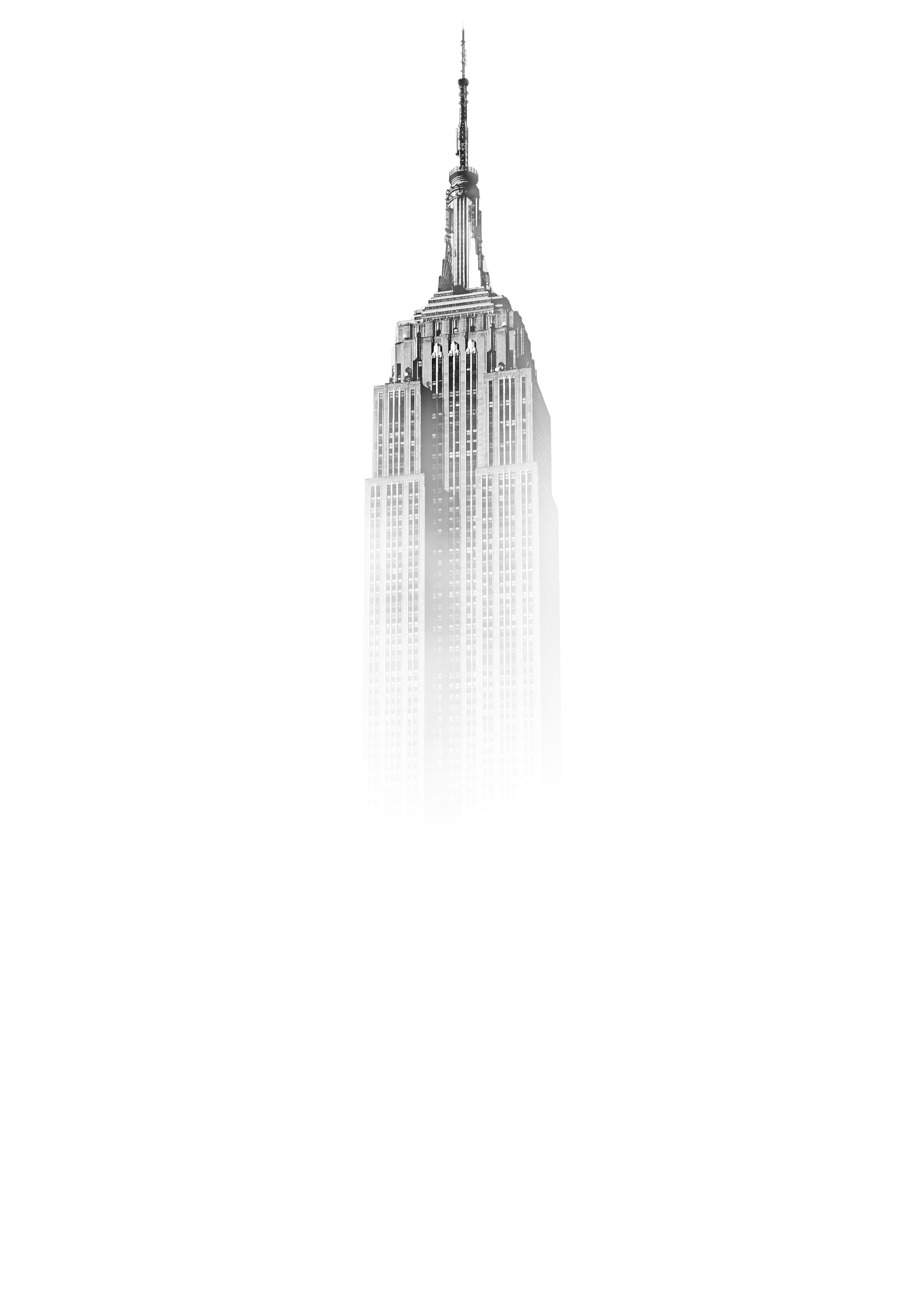 Picture of the top of the empire state building in fog.